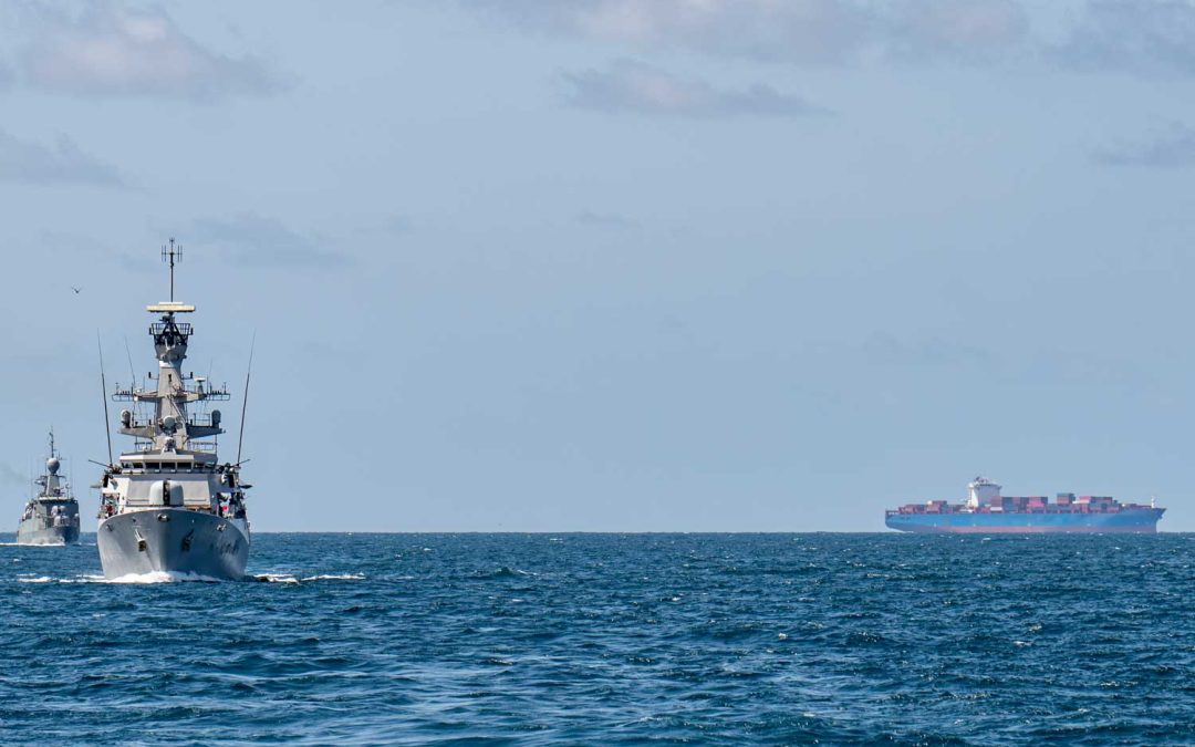 container ship and naval escort